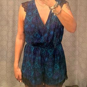 Blue floral romper with lace sleeves and low cut front - Size M